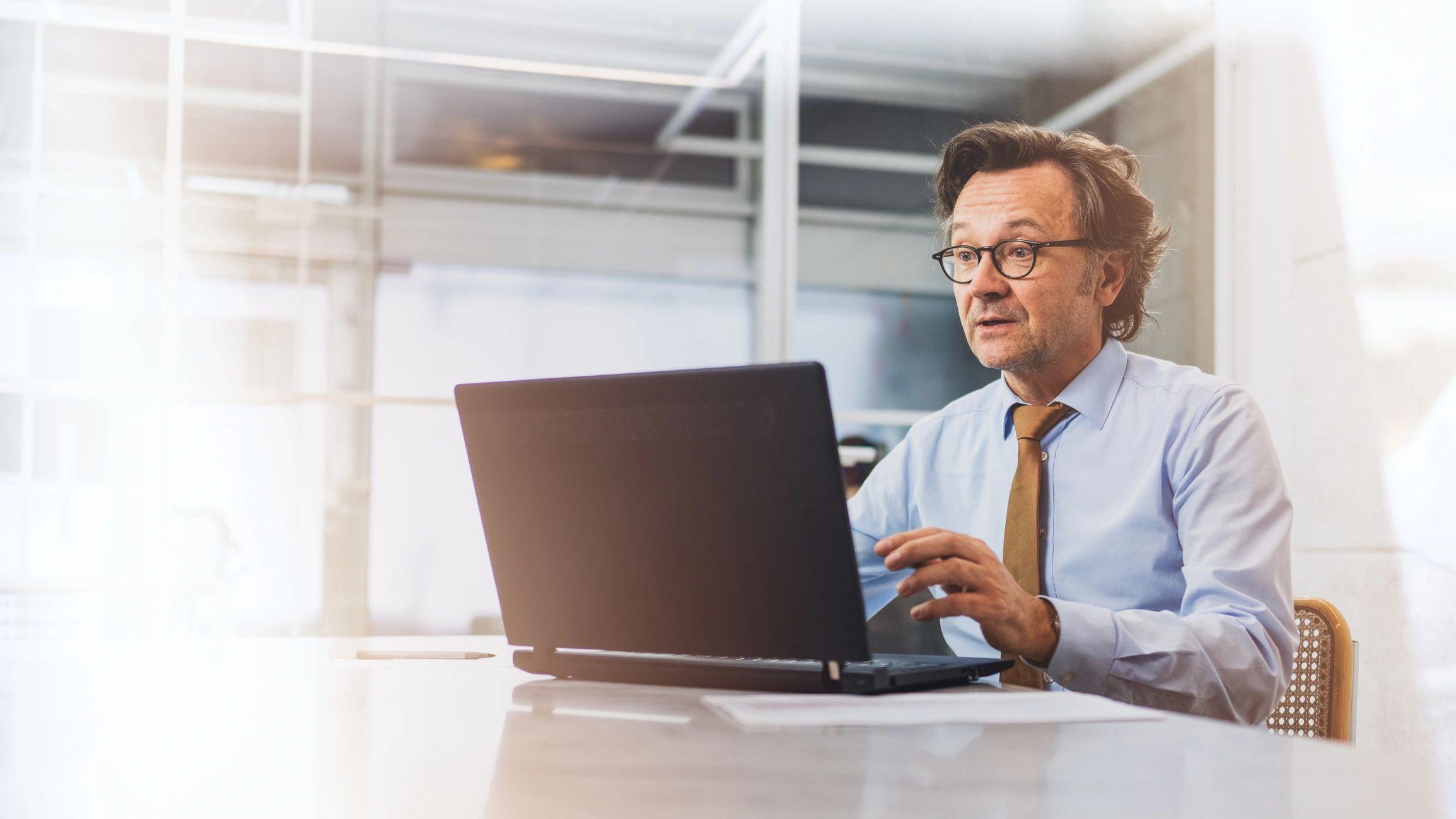 Business owner in a video meeting using a laptop